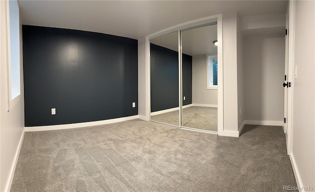 2201 Lima St, Aurora, CO 80010 - unfurnished bedroom featuring baseboards, a closet, and carpet