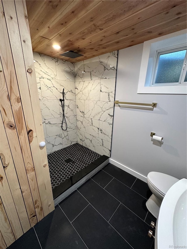 2201 Lima St, Aurora, CO 80010 - bathroom with wood ceiling, tile patterned flooring, tiled shower, and toilet