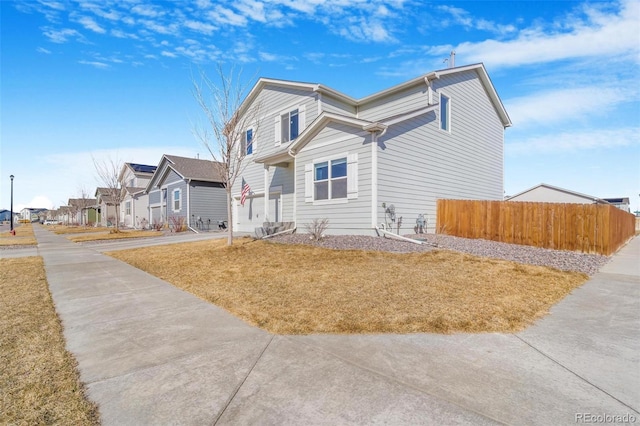 view of front of property featuring a residential view and fence