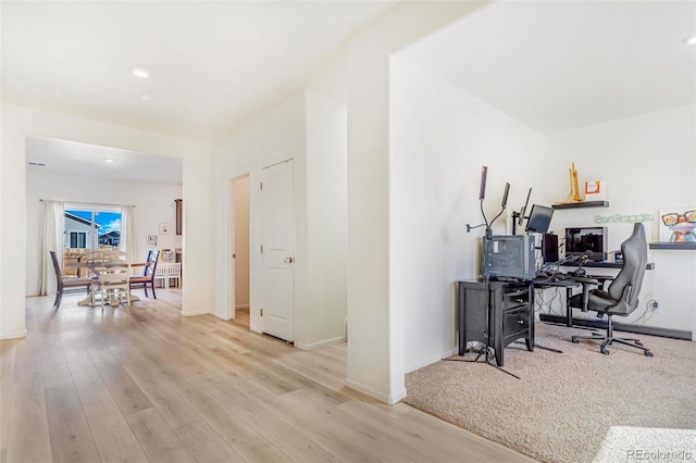 home office featuring light wood-style flooring and baseboards