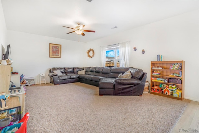 living room with visible vents and a ceiling fan