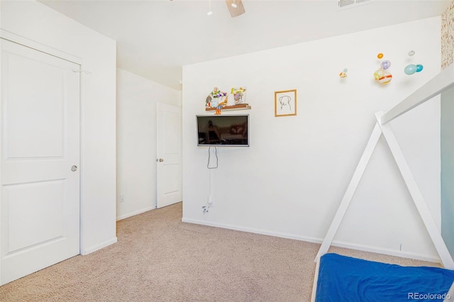 bedroom with carpet floors, visible vents, baseboards, and a ceiling fan