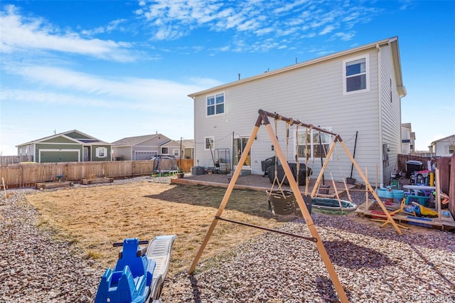 rear view of house with a fenced backyard