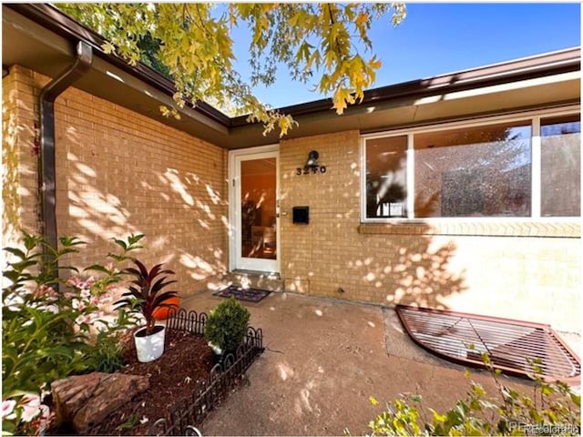 entrance to property featuring a patio area