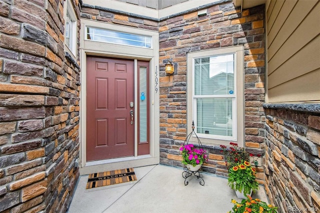 property entrance featuring stone siding