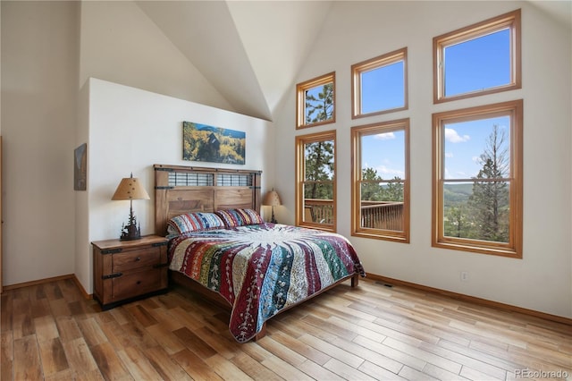 1321 Forest Edge Rd, Woodland Park, CO 80863 - bedroom with light wood-style flooring, baseboards, and high vaulted ceiling
