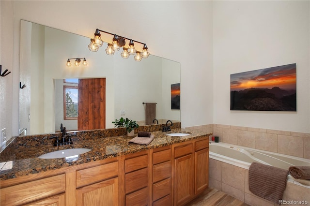 1321 Forest Edge Rd, Woodland Park, CO 80863 - bathroom featuring a bath, double vanity, and wood finished floors