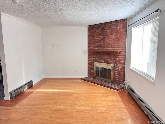 unfurnished living room with a textured ceiling and a baseboard heating unit