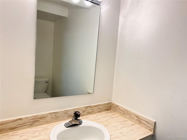 bathroom featuring vanity and toilet