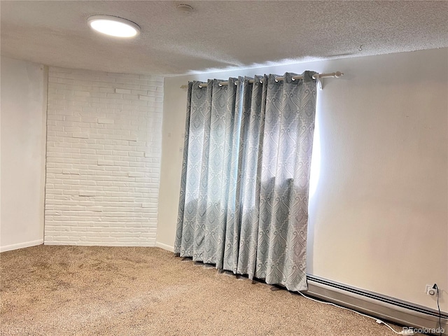 carpeted spare room featuring a textured ceiling