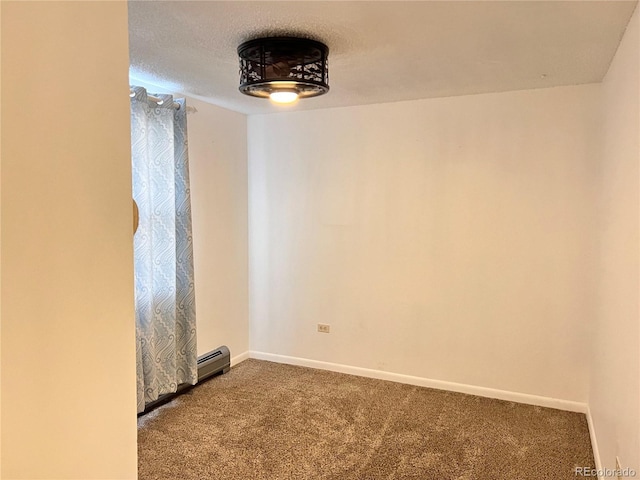 empty room featuring carpet, a textured ceiling, and baseboard heating