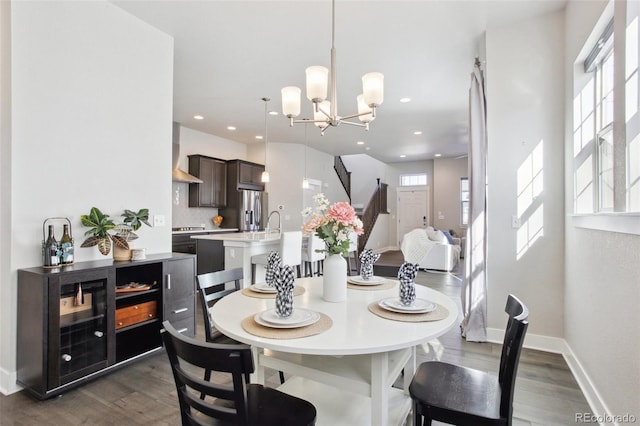 dining room featuring a notable chandelier and dark hardwood / wood-style floors