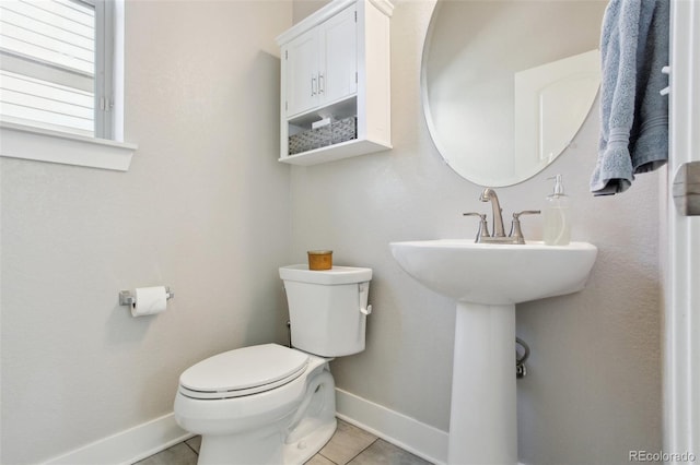 bathroom with tile patterned floors and toilet