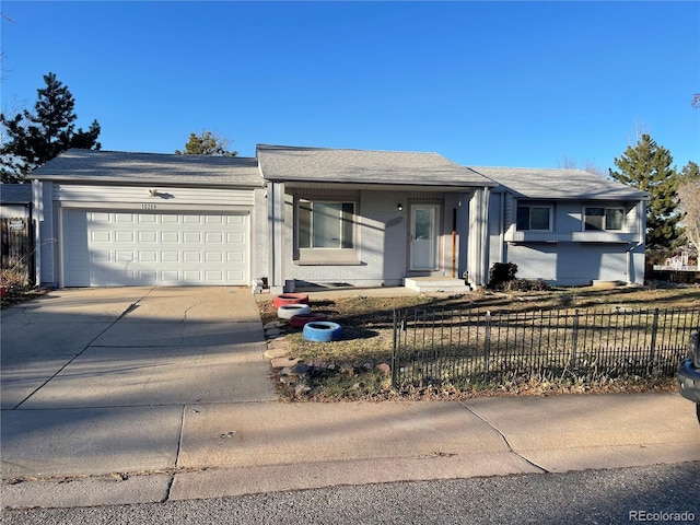 single story home with a garage, concrete driveway, and a fenced front yard