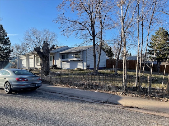 view of front of house with a fenced front yard and driveway