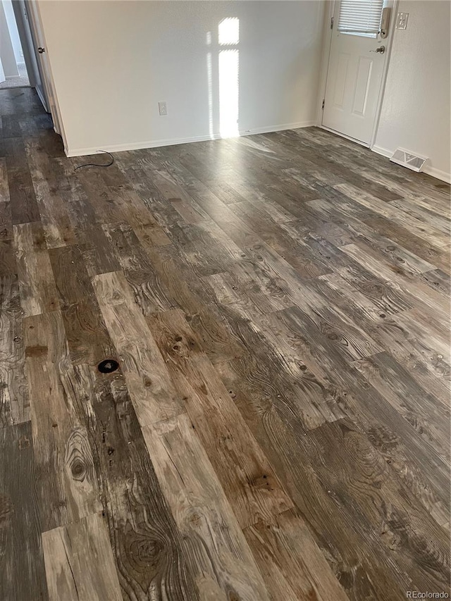 details with wood finished floors, visible vents, and baseboards