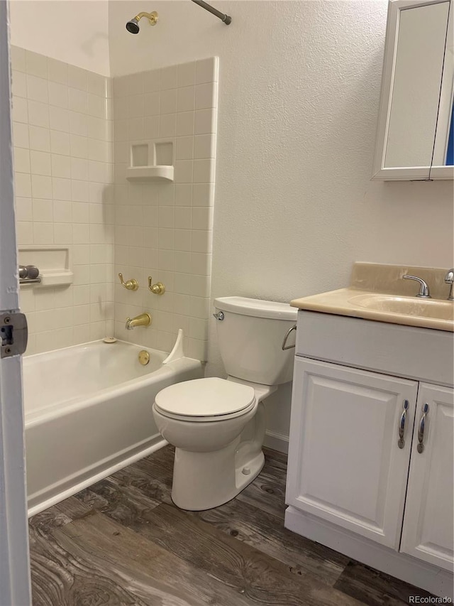 bathroom with shower / bath combination, vanity, toilet, and wood finished floors