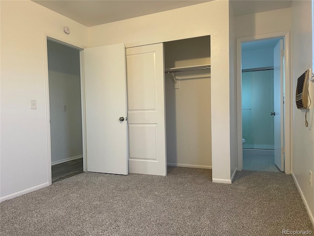 unfurnished bedroom featuring carpet floors, a closet, and baseboards