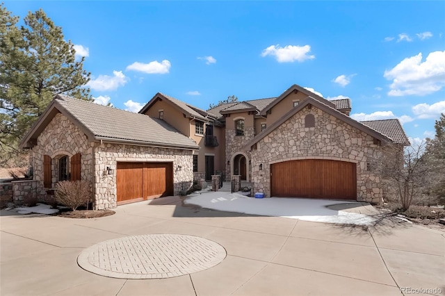 french provincial home featuring a garage