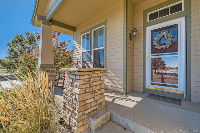 view of exterior entry with covered porch