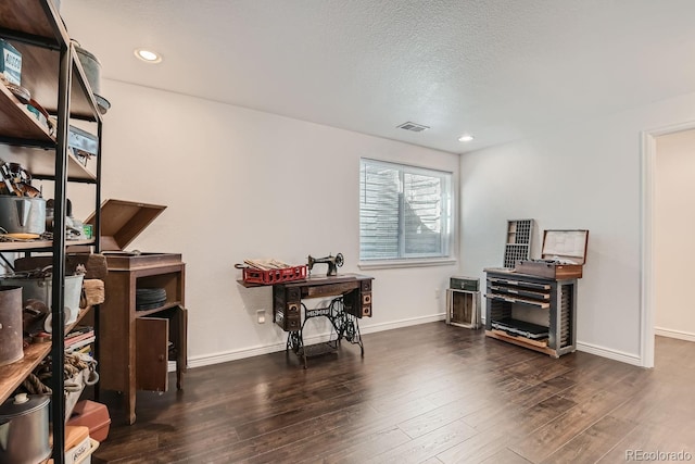 office with dark hardwood / wood-style flooring and a textured ceiling