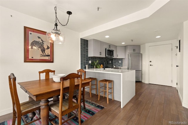 dining space with dark hardwood / wood-style flooring