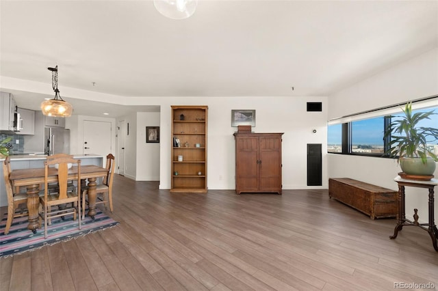 dining room with wood-type flooring