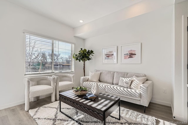 living room featuring recessed lighting, baseboards, and wood finished floors