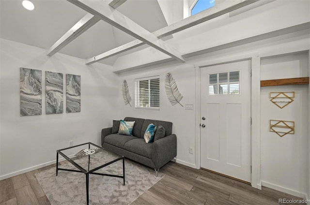 living room with wood finished floors, baseboards, healthy amount of natural light, and beamed ceiling