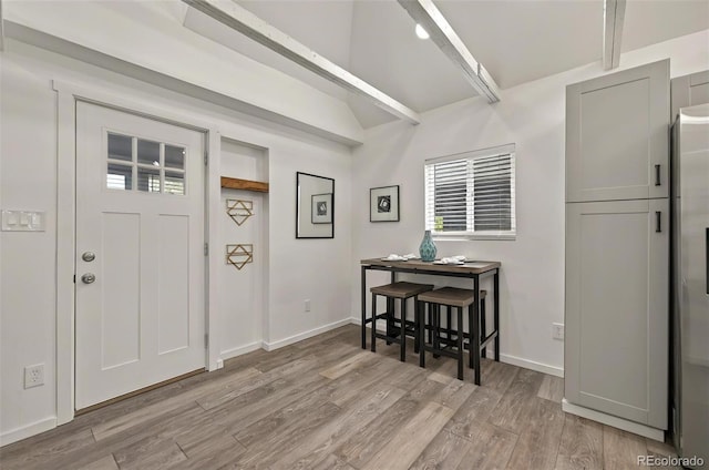 foyer entrance with wood finished floors and baseboards