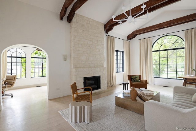 5800 E 6th Avenue Parkway, Denver, CO 80220 - living area featuring high vaulted ceiling, beamed ceiling, healthy amount of natural light, a fireplace, and wood finished floors