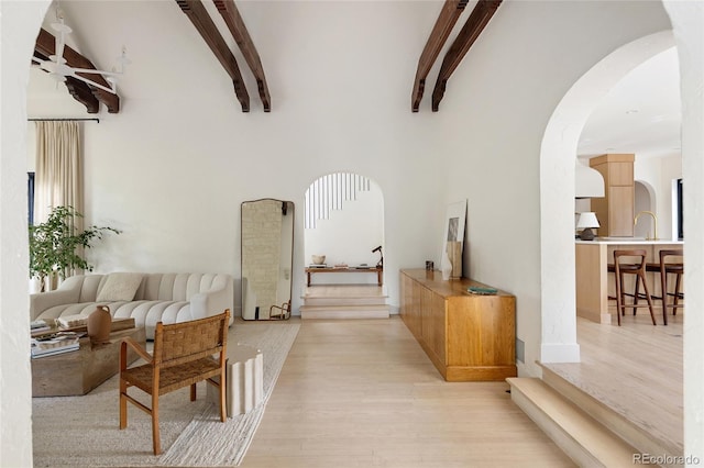 5800 E 6th Avenue Parkway, Denver, CO 80220 - hall featuring arched walkways, light wood-style flooring, and beamed ceiling