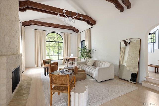 5800 E 6th Avenue Parkway, Denver, CO 80220 - living room with a glass covered fireplace, light wood-type flooring, beam ceiling, a chandelier, and high vaulted ceiling