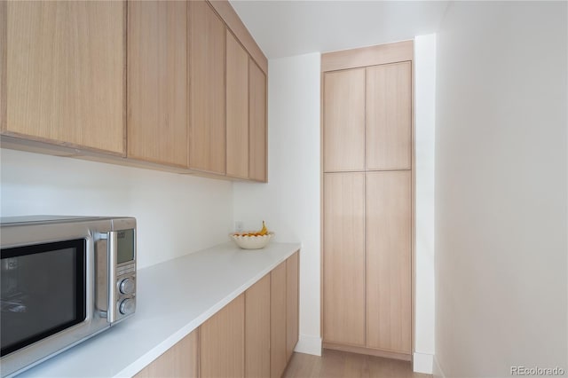 5800 E 6th Avenue Parkway, Denver, CO 80220 - kitchen featuring stainless steel microwave, light brown cabinets, and light countertops