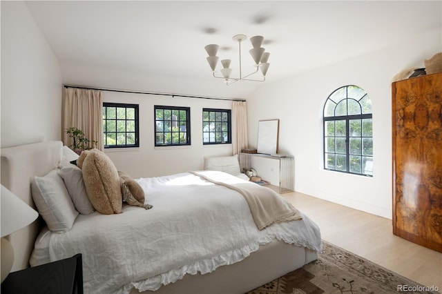 5800 E 6th Avenue Parkway, Denver, CO 80220 - bedroom featuring wood finished floors and a chandelier