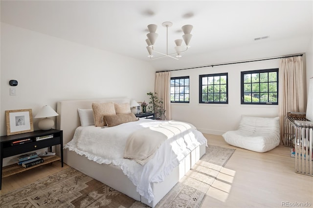 5800 E 6th Avenue Parkway, Denver, CO 80220 - bedroom featuring a chandelier and wood finished floors