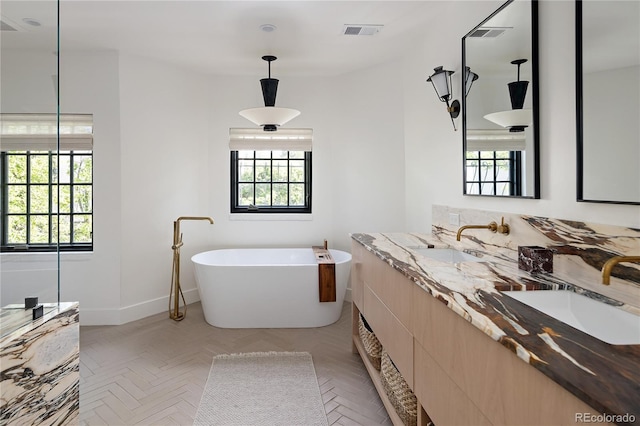5800 E 6th Avenue Parkway, Denver, CO 80220 - bathroom with healthy amount of natural light, a soaking tub, and double vanity