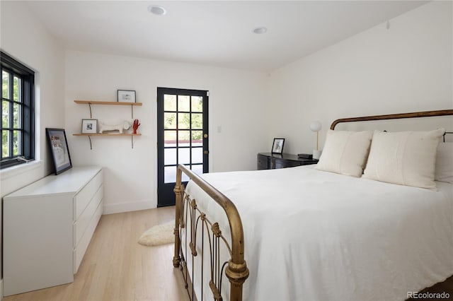 5800 E 6th Avenue Parkway, Denver, CO 80220 - bedroom featuring light wood-style flooring and multiple windows