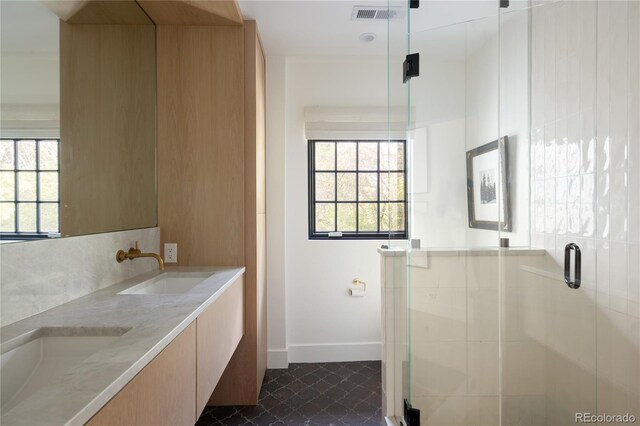 5800 E 6th Avenue Parkway, Denver, CO 80220 - full bathroom featuring double vanity, a shower stall, plenty of natural light, and tile patterned floors