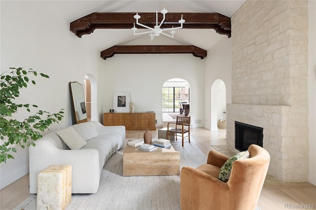 5800 E 6th Avenue Parkway, Denver, CO 80220 - living room with arched walkways, beamed ceiling, a chandelier, high vaulted ceiling, and a stone fireplace