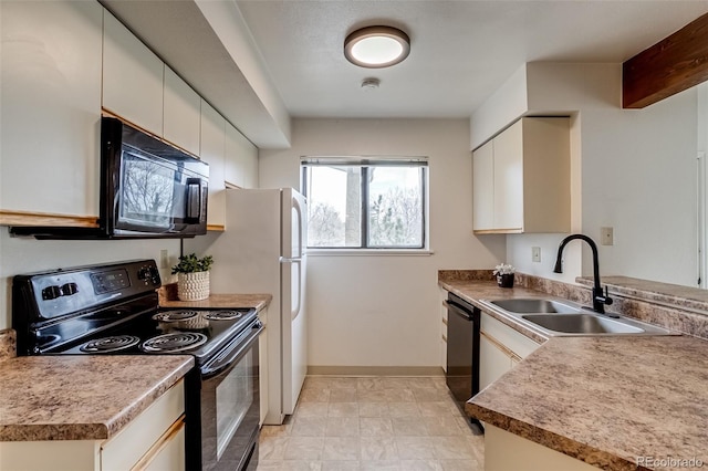 kitchen with baseboards, black appliances, and a sink
