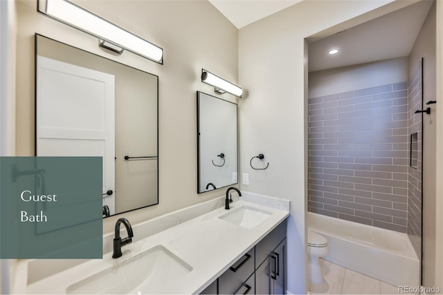 full bathroom with tiled shower / bath combo, toilet, and vanity