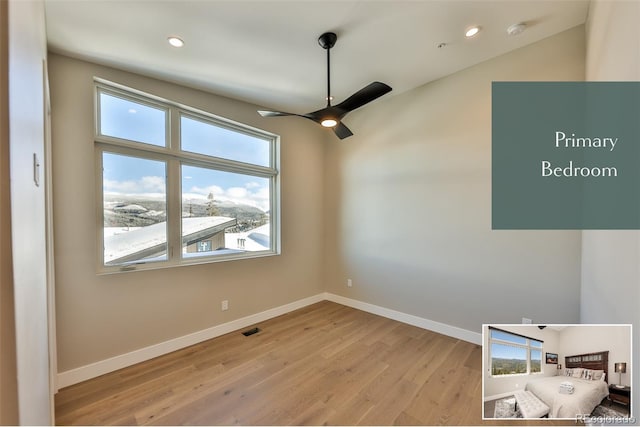 empty room featuring light wood-type flooring and ceiling fan