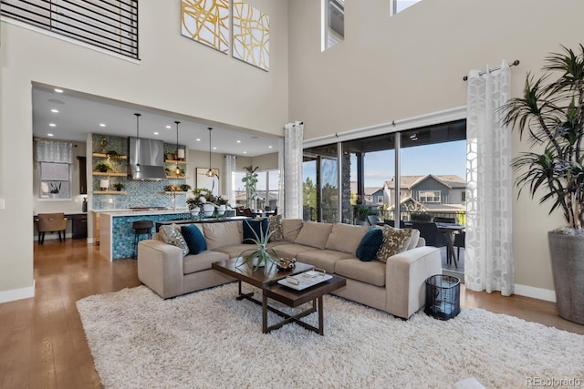 481 Meadowleaf Ln, Highlands Ranch, CO 80126 - living area featuring baseboards, wood finished floors, recessed lighting, and a towering ceiling