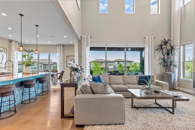 481 Meadowleaf Ln, Highlands Ranch, CO 80126 - living area featuring a high ceiling, wood finished floors, and recessed lighting