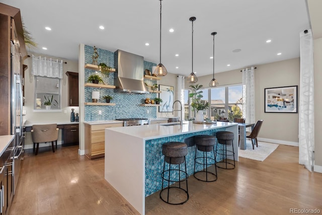 481 Meadowleaf Ln, Highlands Ranch, CO 80126 - kitchen with wall chimney range hood, open shelves, a sink, tasteful backsplash, and light countertops