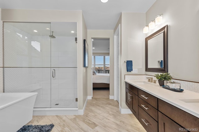 481 Meadowleaf Ln, Highlands Ranch, CO 80126 - full bath featuring a shower stall, ensuite bath, double vanity, wood finished floors, and a freestanding bath
