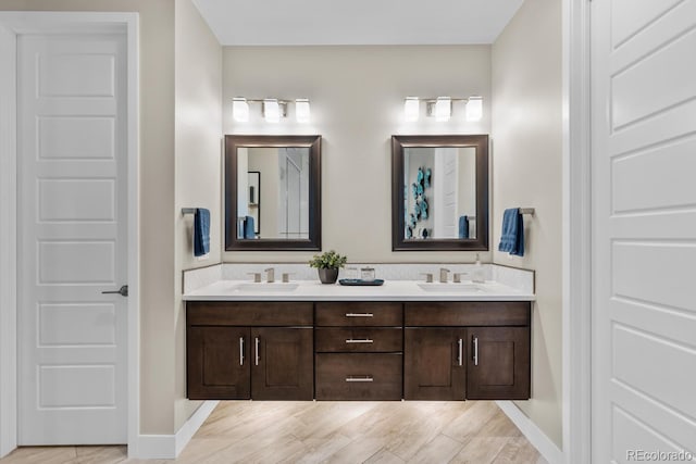 481 Meadowleaf Ln, Highlands Ranch, CO 80126 - full bathroom with double vanity, baseboards, and wood finished floors