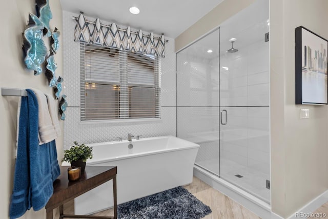481 Meadowleaf Ln, Highlands Ranch, CO 80126 - full bathroom featuring a stall shower, a freestanding bath, wood finished floors, and recessed lighting