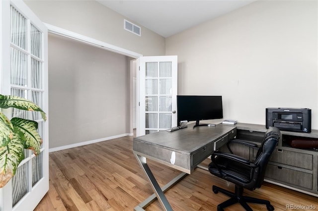 office space featuring visible vents, baseboards, and wood finished floors